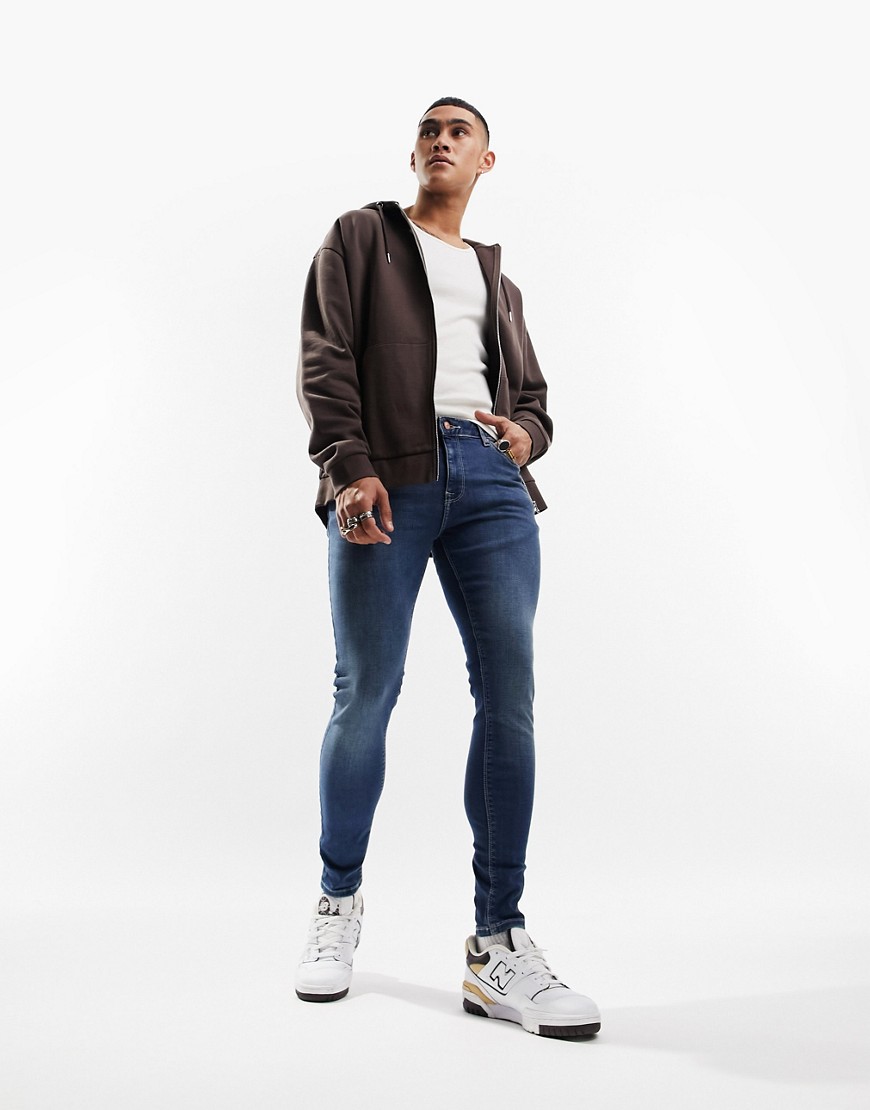 Product photo of Asos design spray on jeans with power stretch in dark wash blue