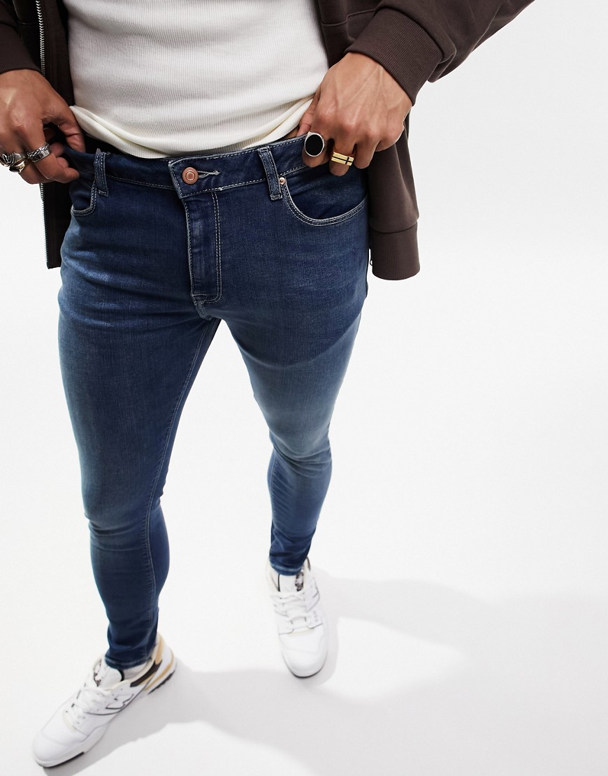 Alternative product photo of Asos design spray on jeans with power stretch in dark wash blue