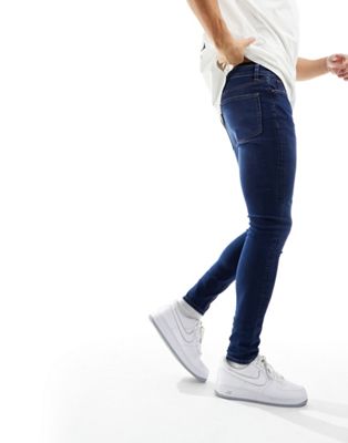 ASOS DESIGN spray on jeans with power-stretch in dark wash blue