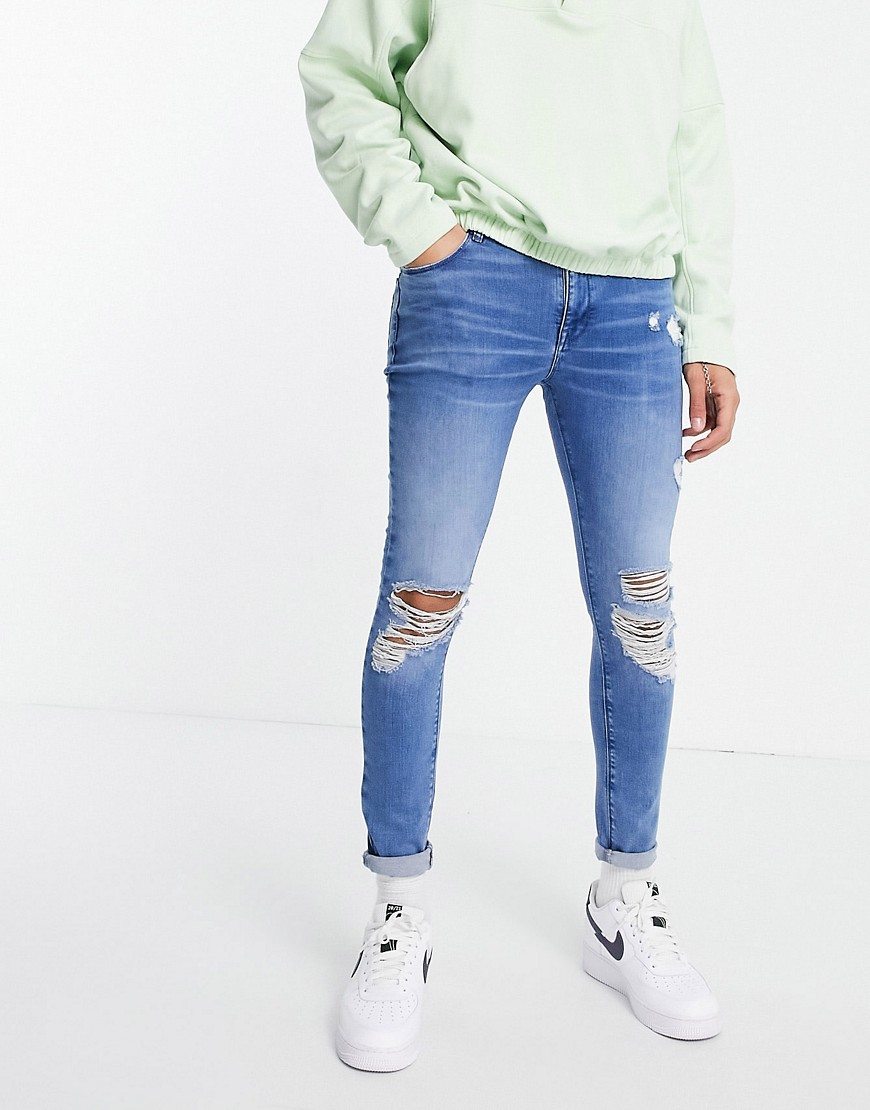 ASOS DESIGN spray on jeans with power stretch in 'less thirsty' vintage light wash-Blues