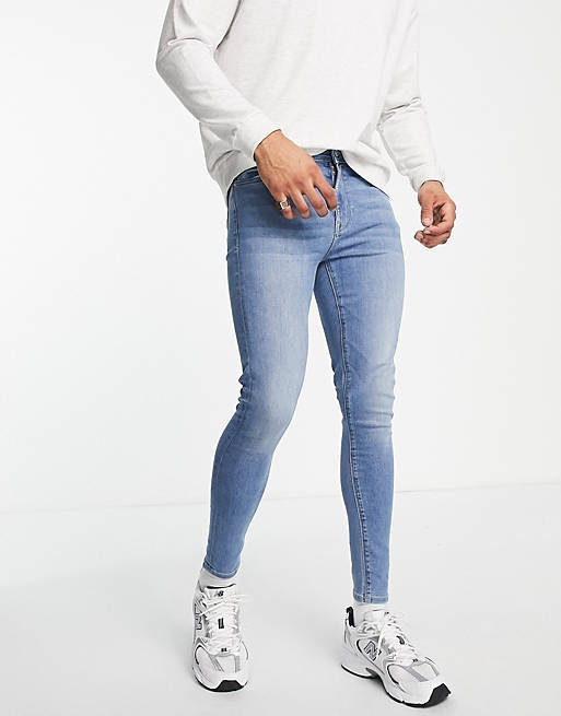 ASOS Herren Kleidung Hosen & Jeans Jeans Stretch Jeans Spray on jeans in power stretch in light wash with ripped hem detail 