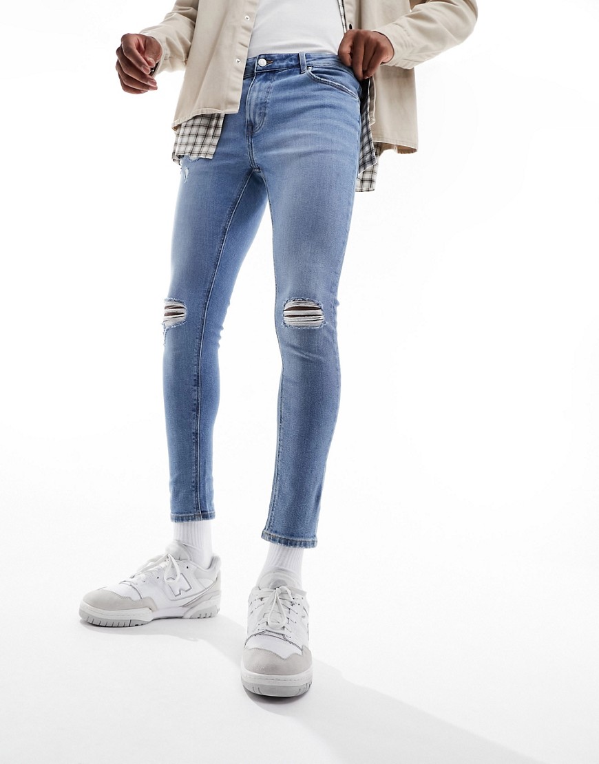 ASOS DESIGN spray on jeans with power stretch in mid blue with knee rips