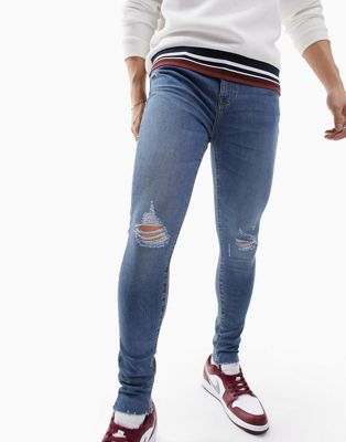 ASOS DESIGN spray on jeans with power stretch in mid wash blue with abrasions  - ASOS Price Checker