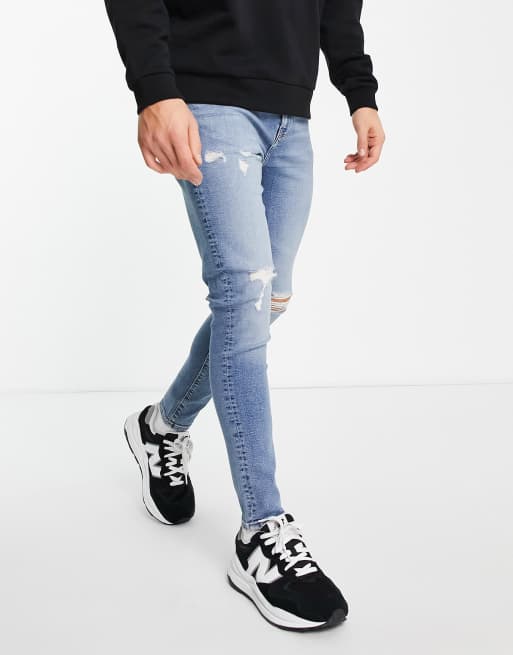 ASOS DESIGN spray on jeans with power stretch in mid wash blue with knee rips ASOS