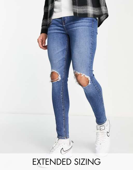 ASOS DESIGN spray on jeans with power stretch in mid wash blue with knee rips 