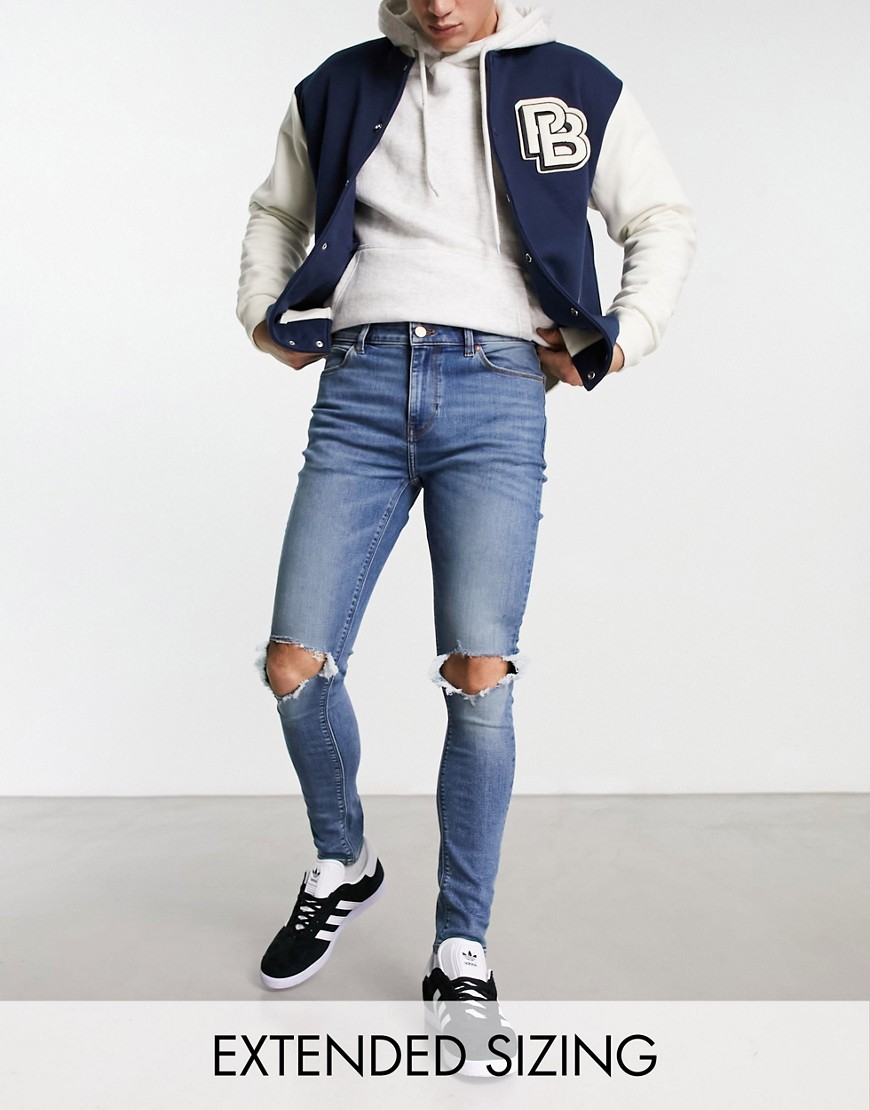 ASOS DESIGN spray on jeans with power stretch in mid wash blue with knee rips