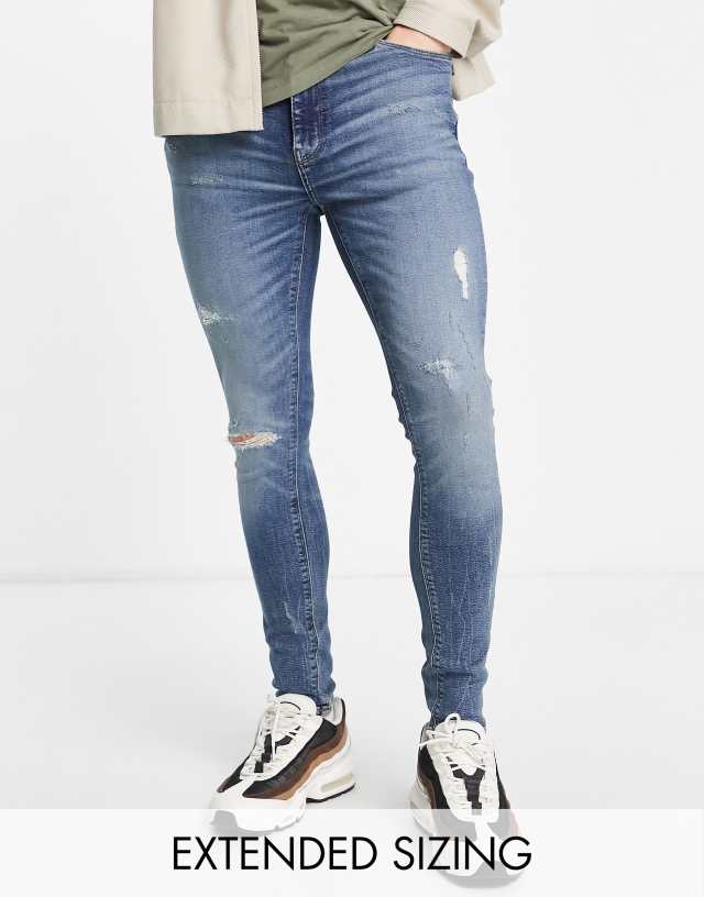 ASOS DESIGN spray on jeans with power stretch in mid wash blue with tint and abrasions