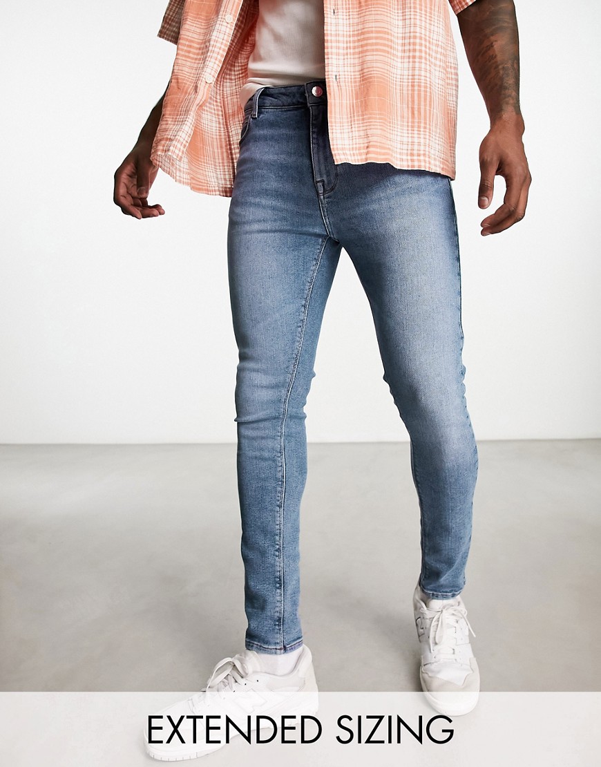 ASOS DESIGN spray on jeans with power stretch in mid wash blue