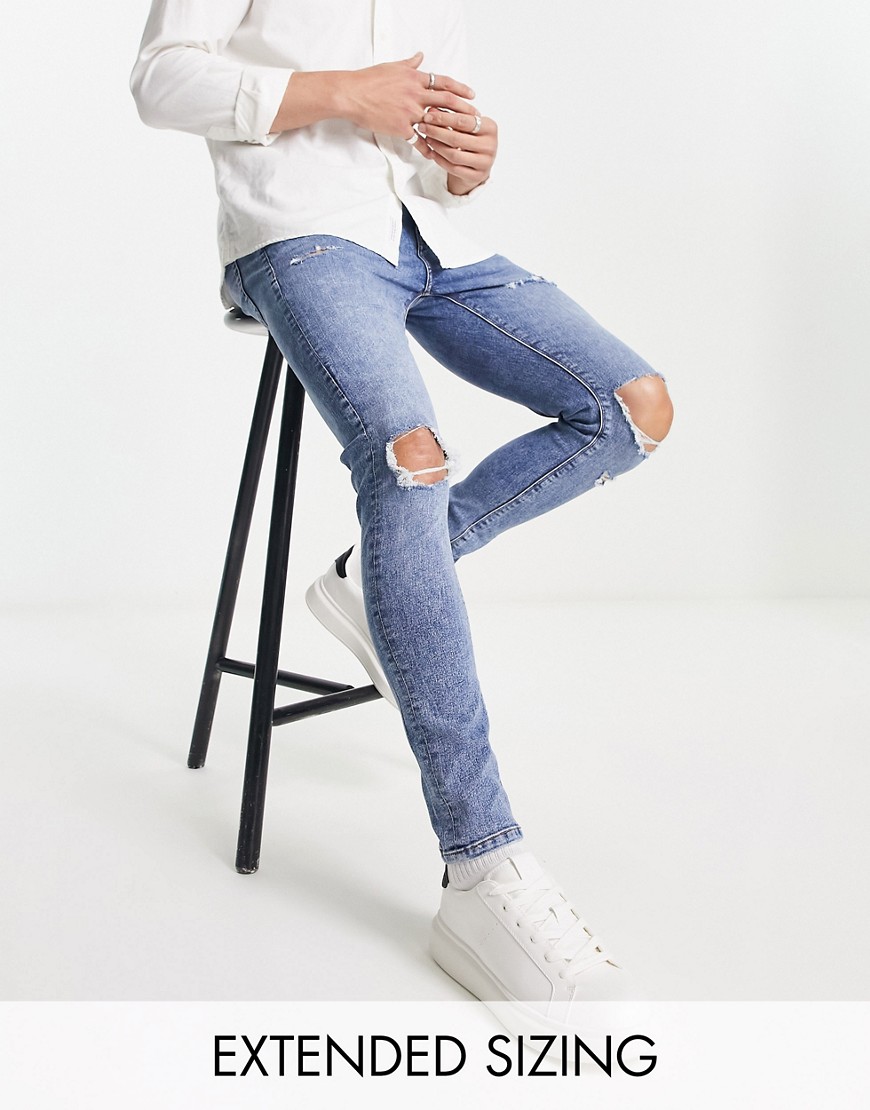 ASOS DESIGN spray on jeans with power stretch in mid wash with knee rips and abrasions-Blue