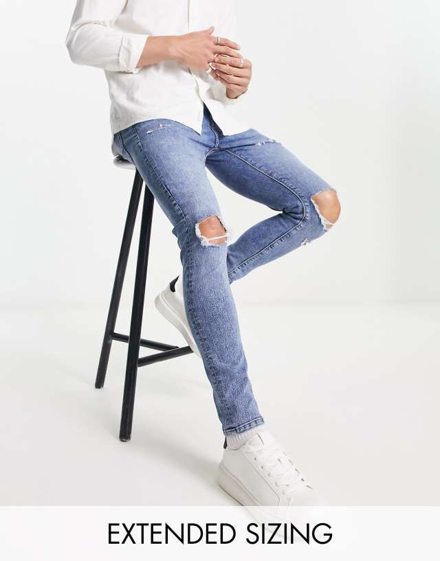 ASOS DESIGN spray on jeans with power stretch in mid wash with knee rips and abrasions