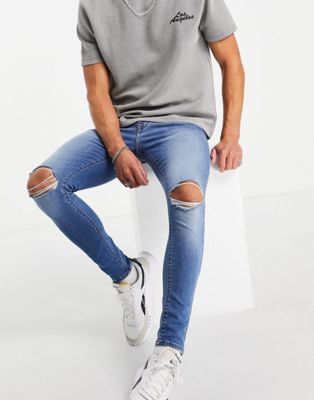 Asos Design Spray On Jeans With Power Stretch In Mid Wash Blue With Knee Rips-blues