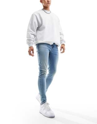 ASOS DESIGN spray on jeans in power stretch denim in light wash