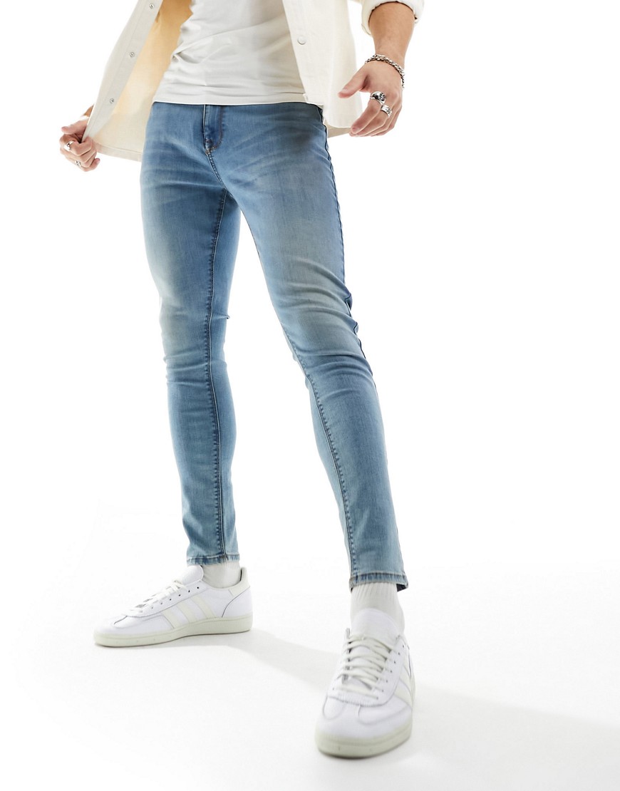 ASOS DESIGN spray on jeans with power stretch in tinted wash blue