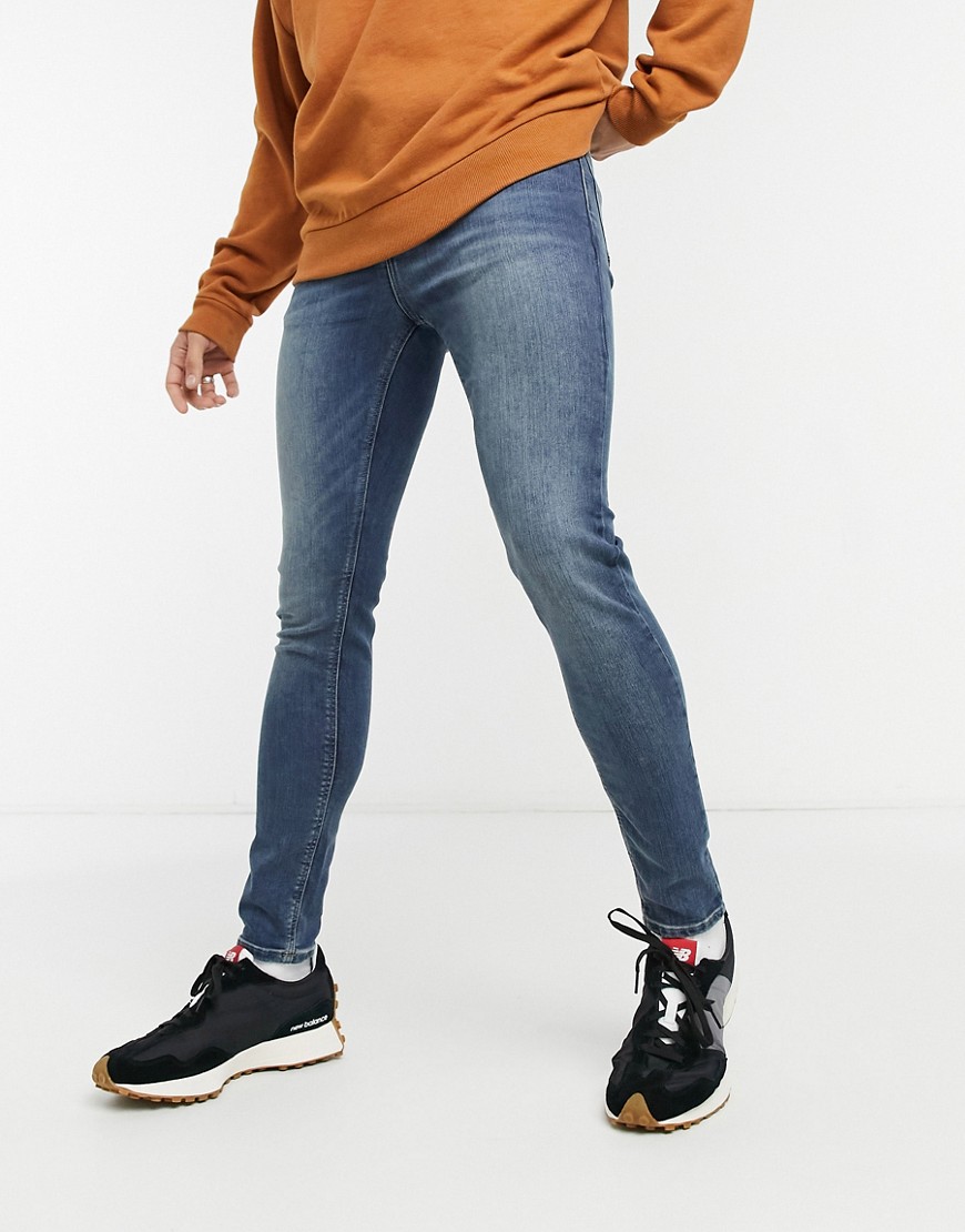 ASOS DESIGN spray on jeans with power stretch in vintage dark wash-Blues