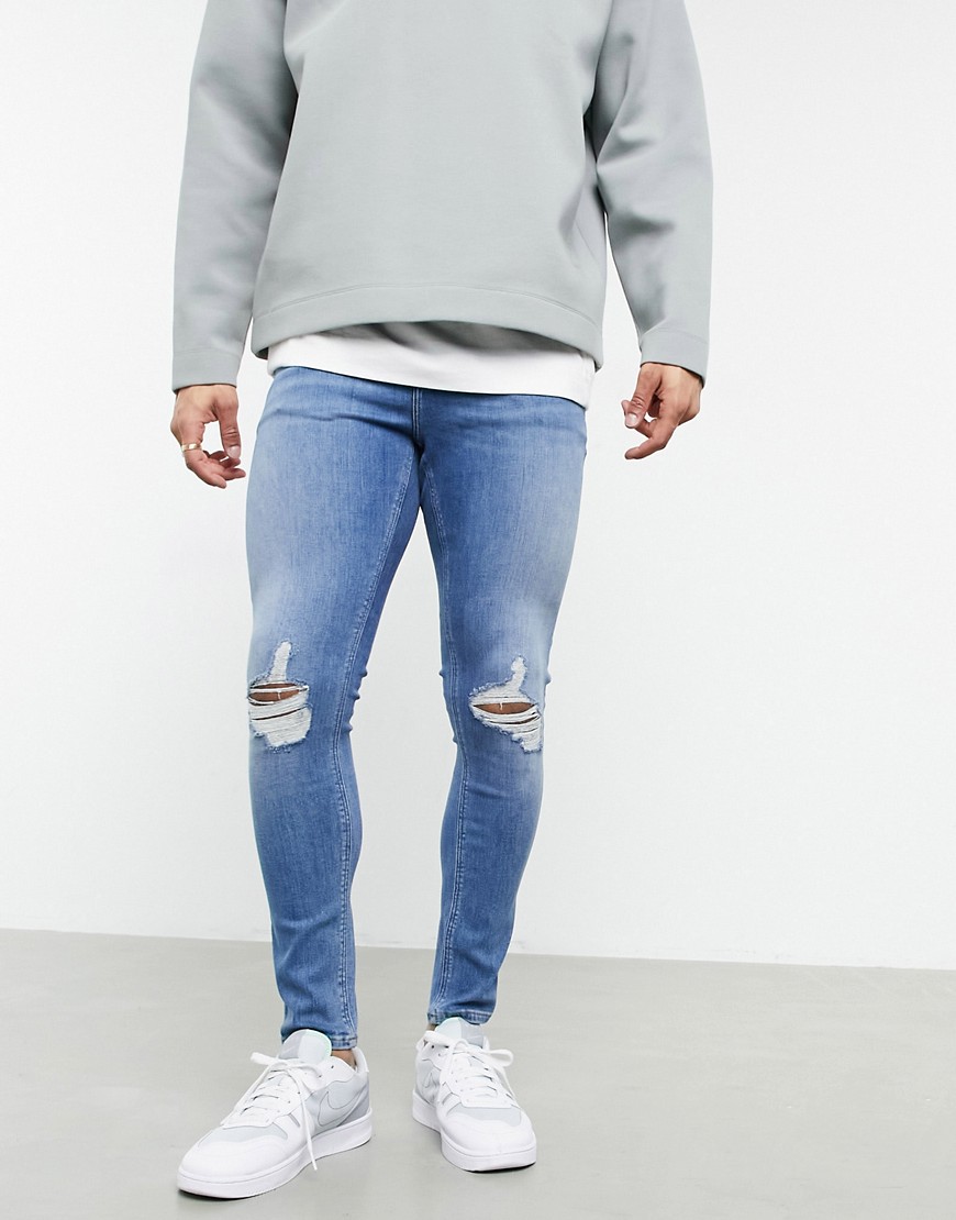 ASOS DESIGN spray on jeans with power stretch in vintage mid wash blue with knee rips-Blues