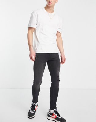 ASOS DESIGN spray on jeans with power stretch in washed black with abrasions