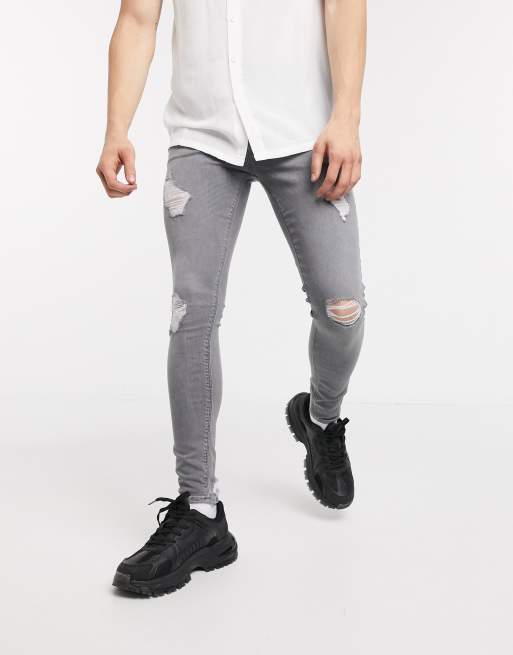 ASOS DESIGN spray on jeans with power stretch with heavy rips in gray