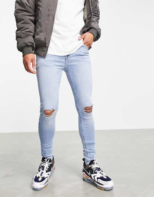 ASOS DESIGN spray on jeans with powerstretch in light wash blue with knee rips