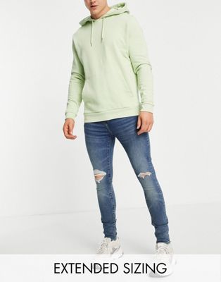 ASOS DESIGN spray on jeans with powerstretch in tinted mid wash with knee rips