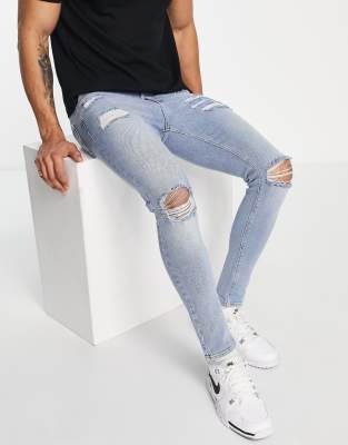 ASOS DESIGN spray on 'vintage look' jeans with power stretch in light wash blue with heavy rips