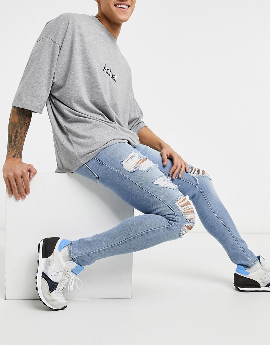 ASOS DESIGN spray on 'vintage look' jeans with power stretch in light wash blue with heavy rips-Blues