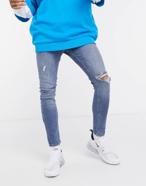ASOS DESIGN spray on 'vintage look' jeans with power stretch in mid blue with knee rip