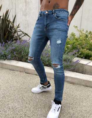 ASOS DESIGN spray on'vintage look' jeans with power stretch in dark wash blue with abrasions