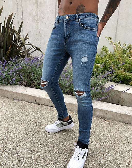 ASOS DESIGN spray on'vintage look' jeans with power stretch in dark wash blue with abrasions