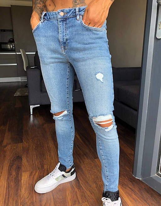 ASOS DESIGN spray on'vintage look' jeans with power stretch in mid wash blue with knee rips