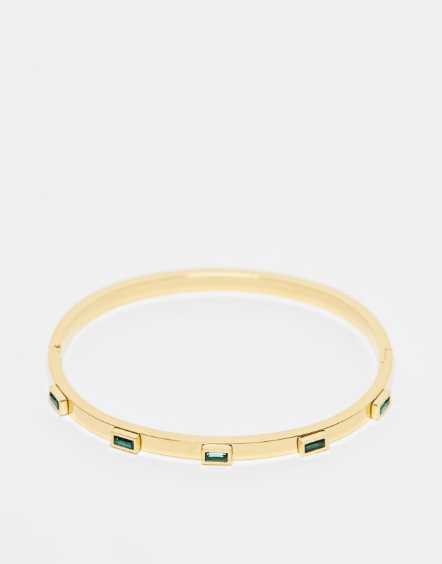 ASOS DESIGN stainless steel bangle with green baguette crystal design in gold tone