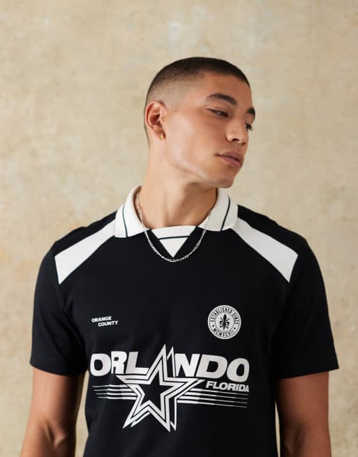 ASOS DESIGN standard fit polo with city graphic in black