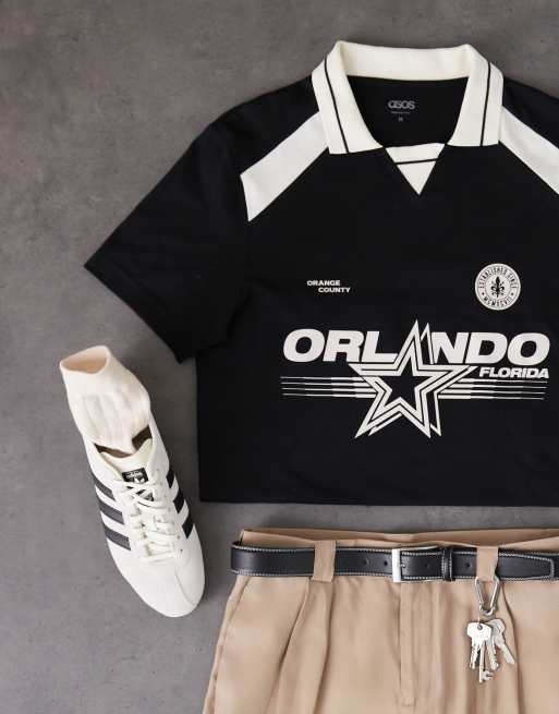ASOS DESIGN standard fit polo with city graphic in black