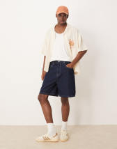 ASOS DESIGN swim shorts in short length with animal print in navy