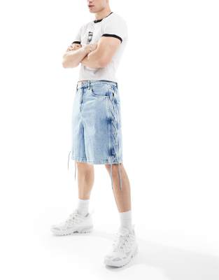 standard length denim jorts with tie up detail in light wash blue