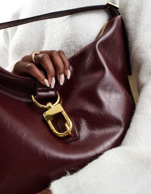 ASOS DESIGN statement buckle slouchy tote bag in burgundy