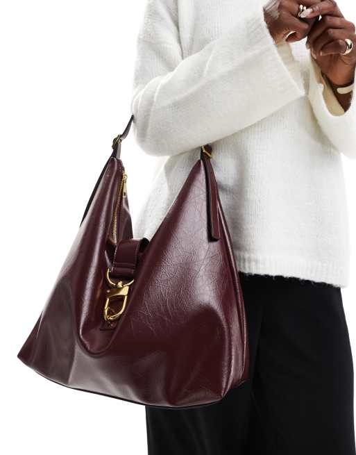 ASOS DESIGN statement buckle slouchy tote bag in burgundy