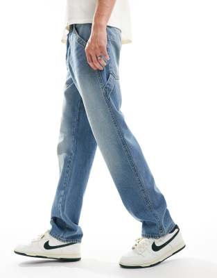 straight leg carpenter jeans with vintage tint in light wash blue