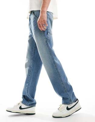 straight leg jeans with carpenter details in light wash blue