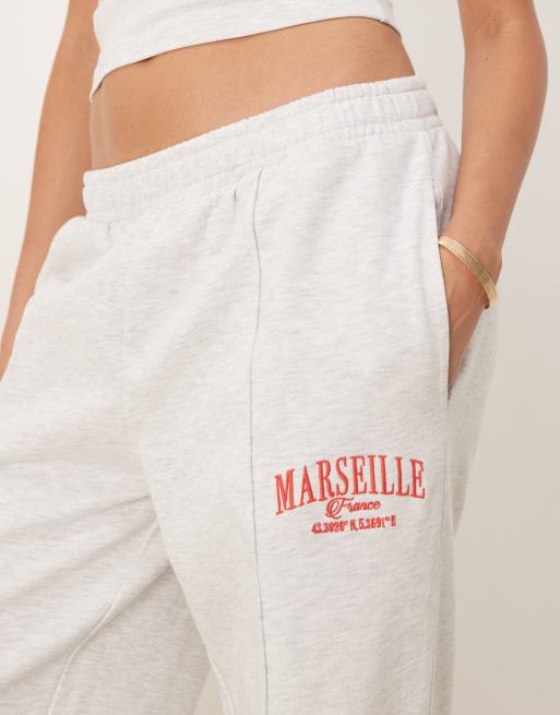 ASOS DESIGN straight leg sweatpants with Marseille embroidered graphic in ice heather, 5 of 5