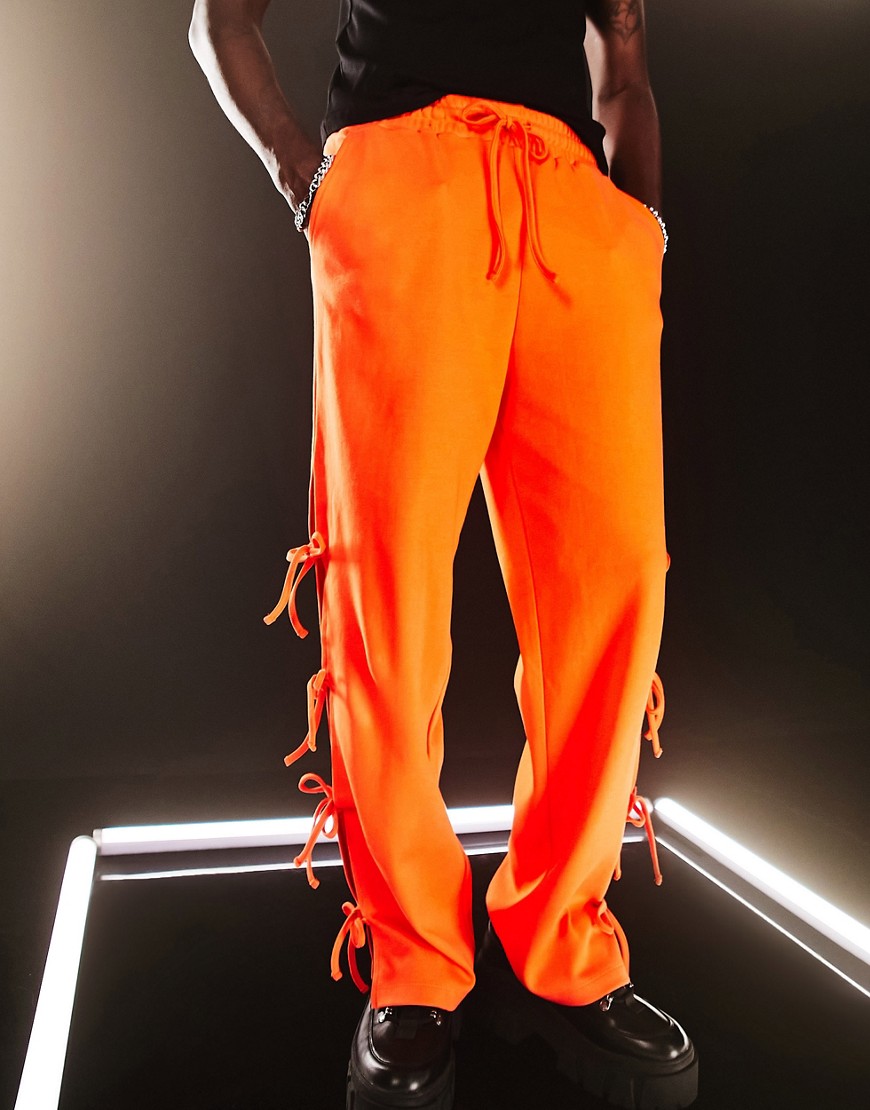 ASOS DESIGN straight leg sweatpants with tie details in red-Orange