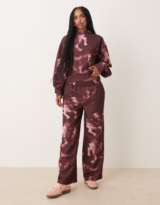 ASOS DESIGN straight leg trackies with all over floral design in plum (part of a set)