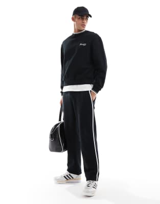 ASOS DESIGN straight leg trackies with textured side stripes in black ...