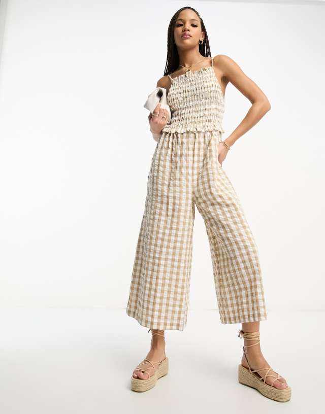 ASOS DESIGN strappy high neck shirred jumpsuit in gingham