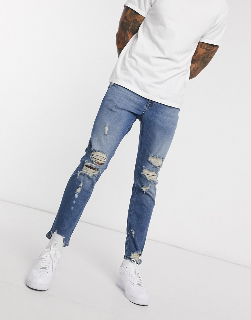 ASOS DESIGN stretch slim jeans in blue with heavy rips