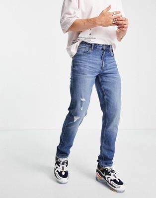 ASOS DESIGN stretch slim jeans in dark wash blue with abrasions  - ASOS Price Checker