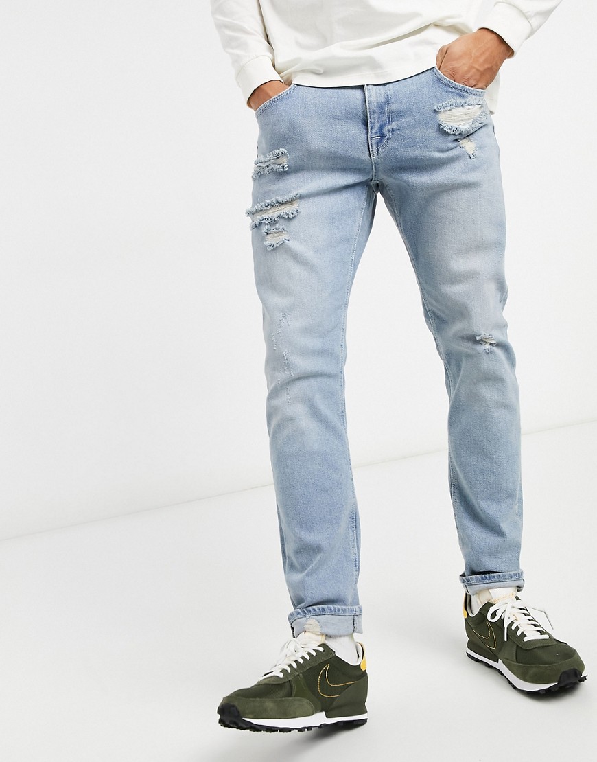 ASOS DESIGN stretch slim jeans in distressed light wash blue-Blues