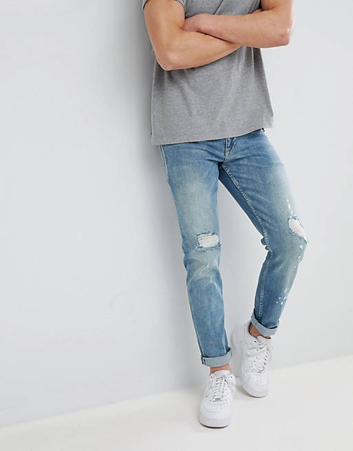 ASOS DESIGN stretch slim jeans in mid wash blue with rips