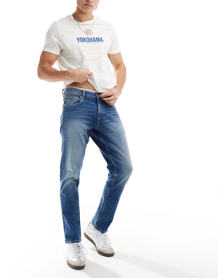 ASOS DESIGN stretch slim jeans in mid wash blue