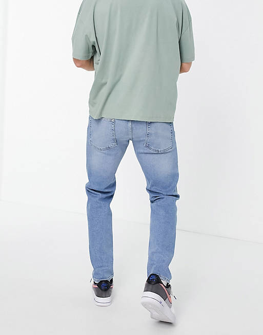 ASOS DESIGN stretch slim jeans in mid wash with rips