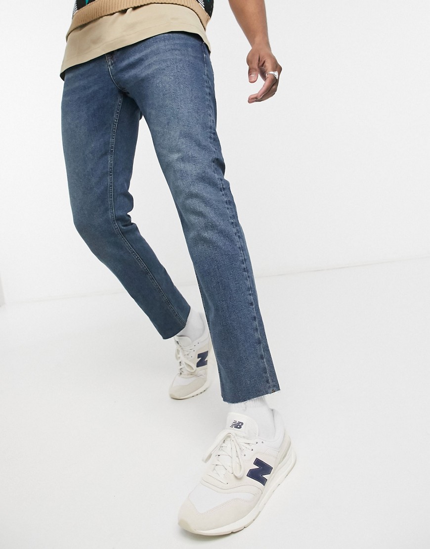 ASOS DESIGN stretch slim jeans in tinted mid blue with raw hem
